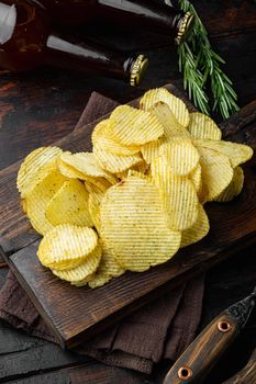 Salty potato chips snack set, on old dark wooden table