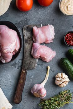 Raw gyros ingredients, chicken meat on grey background, flat lay.