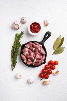 Raw turkey hearts set, on white stone table background, top view flat lay, with copy space for text