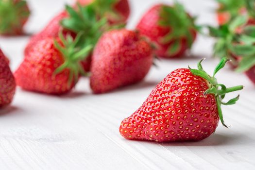 Red Strawberry, red close up strawberries with selective focus on a strawberry with many strawberries in the background for food or fruit close up background or strawberry texture.