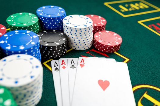 Poker play. Chips and cards on the green table