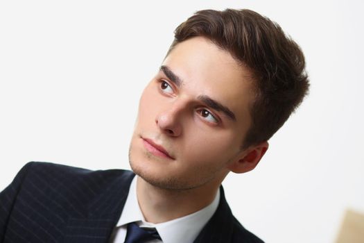 Portrait of handsome young man looking away, pensive look, thoughtful mood. Manager in suit think about new idea, creative mind. Business, startup concept
