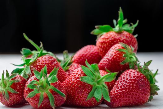 Red Strawberry, red close up strawberries with selective focus on a strawberry with many strawberries in the background for food or fruit close up background or strawberry texture.