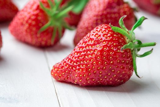 Red Strawberry, red close up strawberries with selective focus on a strawberry with many strawberries in the background for food or fruit close up background or strawberry texture.