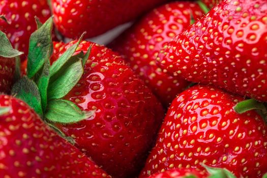 Red Strawberry, red close up strawberries with selective focus on a strawberry with many strawberries in the background for food or fruit close up background or strawberry texture.