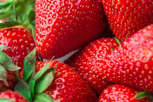 Red Strawberry, red close up strawberries with selective focus on a strawberry with many strawberries in the background for food or fruit close up background or strawberry texture.