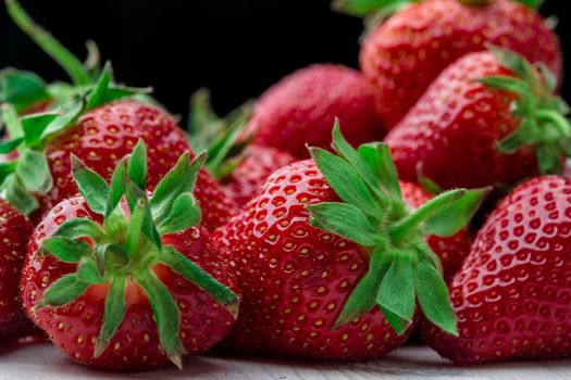 Red Strawberry, red close up strawberries with selective focus on a strawberry with many strawberries in the background for food or fruit close up background or strawberry texture.