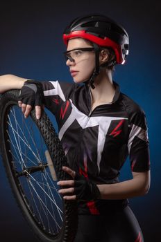 the girl cyclist in a helmet