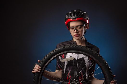 the girl cyclist in a helmet