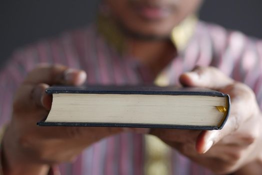 muslim man hand holding Holy book Quran with copy space ,