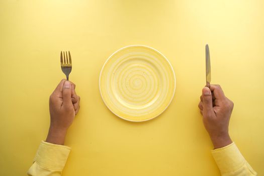 cutlery and empty plate on wooden background