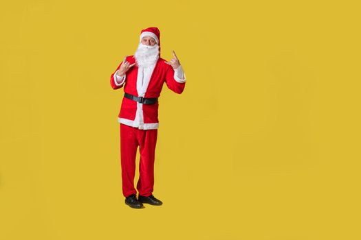 Santa claus yellow funny stylish, fat fast background man new, suit people. Caucasian red, white heyv metal sign on fingers