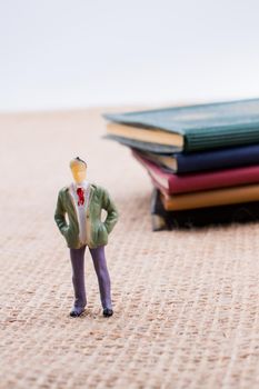 Man figurine standing inside the pages of the  book