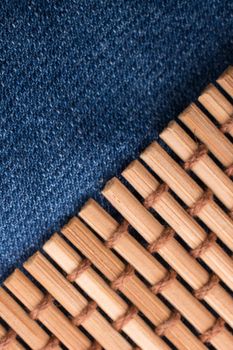 Straw mat placed on denim canvas as  a background