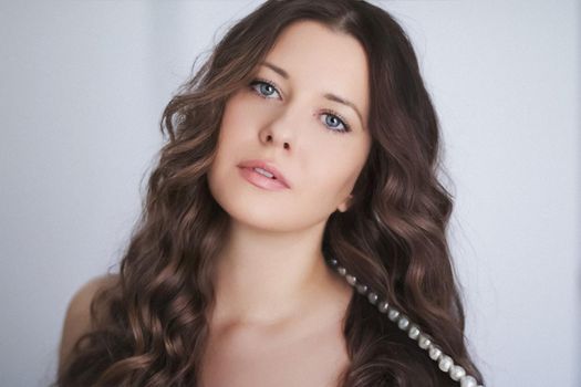 Hairstyle model and beauty face closeup. Beautiful woman with long straight brown hair styled in curly waves, classic glamour style and luxury fashion portrait.