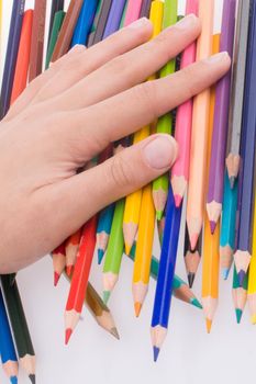 Hand holding Color pencils on a white background