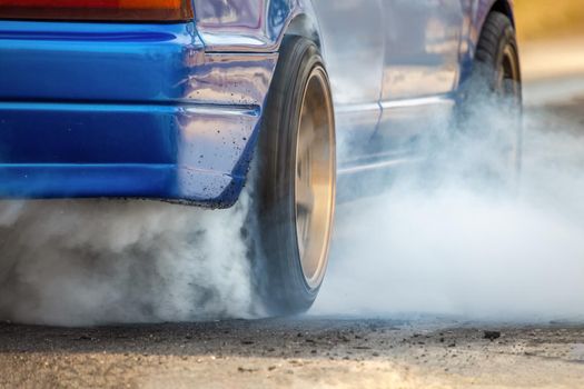 Drag racing car burns rubber off its tires in preparation for the race