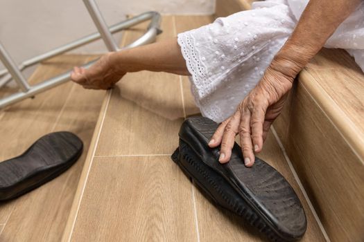 Elderly woman with walker falling down stair