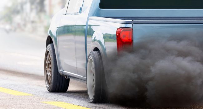 air pollution crisis in city from diesel vehicle exhaust pipe on road