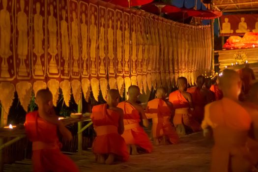 Visakha Puja Day (Vesak). Buddhist monk fire candles and pray to the Buddha in  Chiang Mai Thailand.