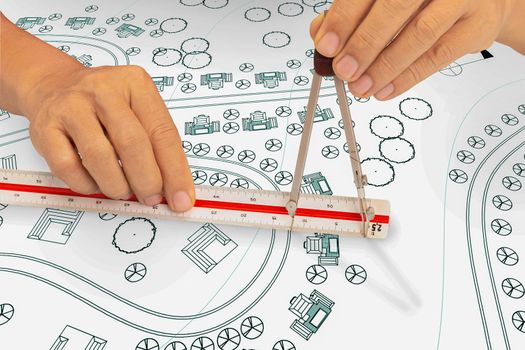 landscape architect student use dividers and scale ruler on blueprint  in class.