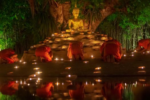 Visakha Puja Day (Vesak). Buddhist monk fire candles and pray to the Buddha in  Chiang Mai Thailand.