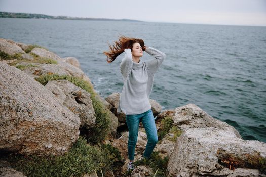 woman freedom walk on the stone coast Lifestyle. High quality photo