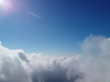 Footage B roll Aerial view drone flying above white clouds dense fog move quickly. Drone flies high back in blue sky through fluffy clouds. Beautiful foggy and cloudy slow moving Aerial view. Fog sea.