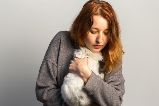 Sad woman holding a pet rabbit. Animal therapy treatment from depression and other emotional problems