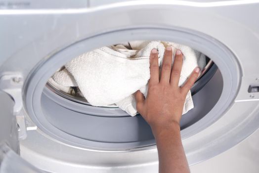 putting towel and cloths in a washing machine