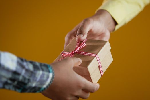 men hand giving homemade gift box .