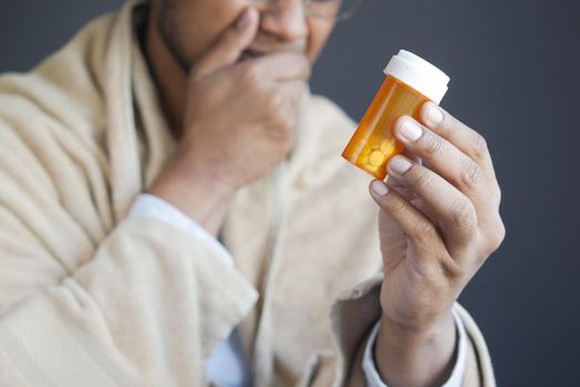 young man hand holding medicine pill container .