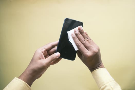 man hand cleaning mobile phone display