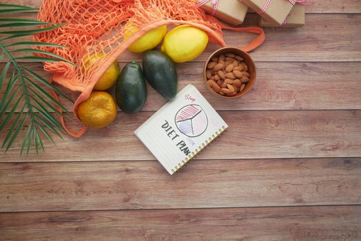 Diet plan with fresh fruits in table .
