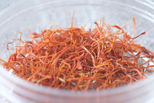 Saffron Spice in a container on table close up .