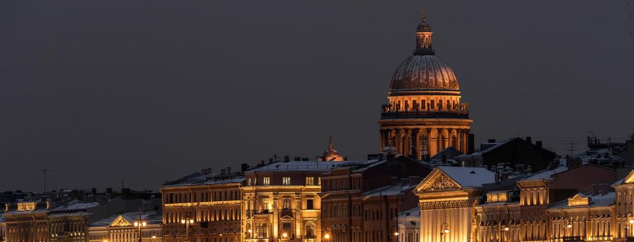 The panoramic footage of the winter night city Saint-Petersburg with picturesque reflection n water, Isaac cathedral on background, Blagoveshchensky bridge, old name is the lieutenant Schmidt. High quality photo