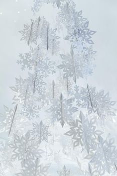 Decoration of paper white snowflakes in the form of a Christmas tree. High quality photo