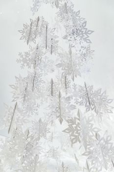 Decoration of paper white snowflakes in the form of a Christmas tree. High quality photo