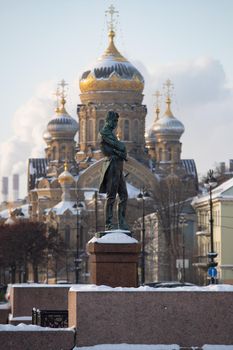 monument to the navigator Kruzenshtern in front of the Cathedral of Lieutenant Schmidt on a clear winter frosty day, golden dome and cross of church. High quality photo