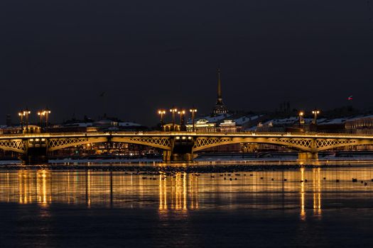 The panoramic footage of the winter night city Saint-Petersburg with picturesque reflection n water, Isaac cathedral on background, Blagoveshchensky bridge, old name is the lieutenant Schmidt. High quality photo