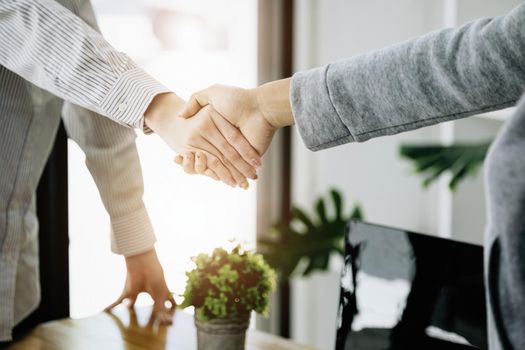 Businesswoman handshake for teamwork of business merger and acquisition,successful negotiate,hand shake,two business woman shake hand with partner to celebration partnership and business deal concept