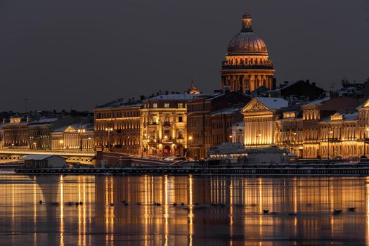 The panoramic footage of the winter night city Saint-Petersburg with picturesque reflection n water, Isaac cathedral on background, Blagoveshchensky bridge, old name is the lieutenant Schmidt. High quality photo
