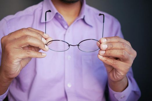 Close up of man hand holding eyeglass,