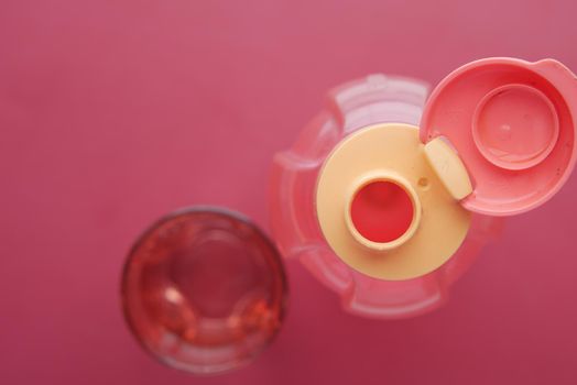 fresh eater in a plastic container on red background .