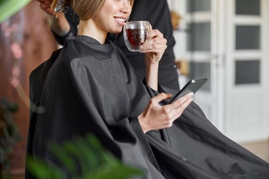 Happy beautiful light hair caucasian woman at beauty salon