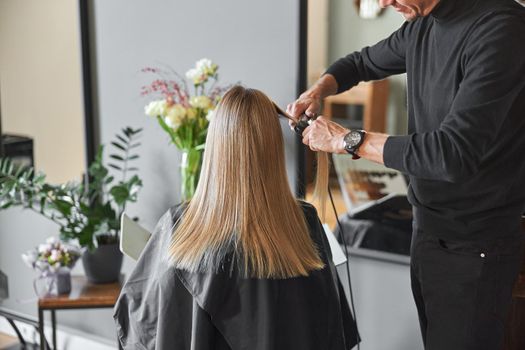 Happy beautiful light hair caucasian woman at beauty salon