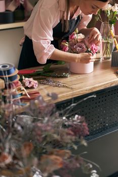 happy professional woman is working in flower shop