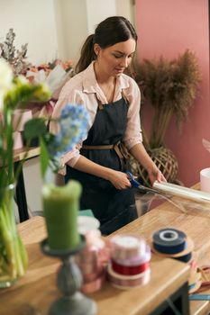 happy professional woman is working in flower shop