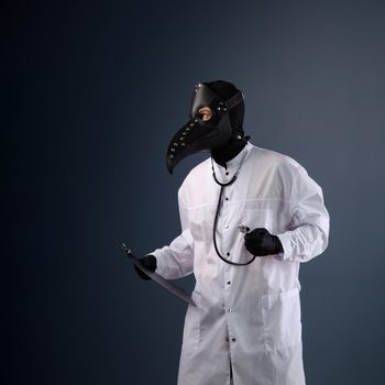 doctor in a dressing gown wearing a plague doctor mask with a stethoscope in his hands