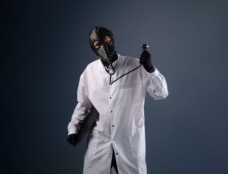 doctor in a dressing gown wearing a plague doctor mask with a stethoscope in his hands